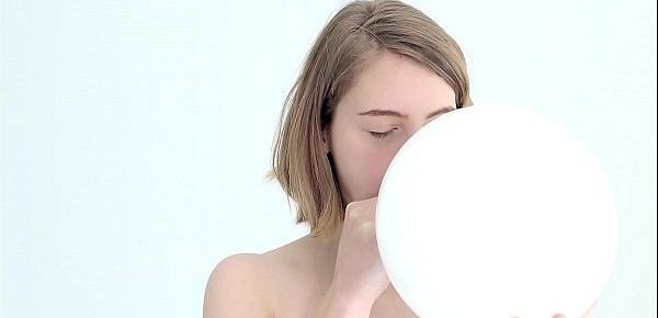  Young looner babe blowing and popping her first balloon